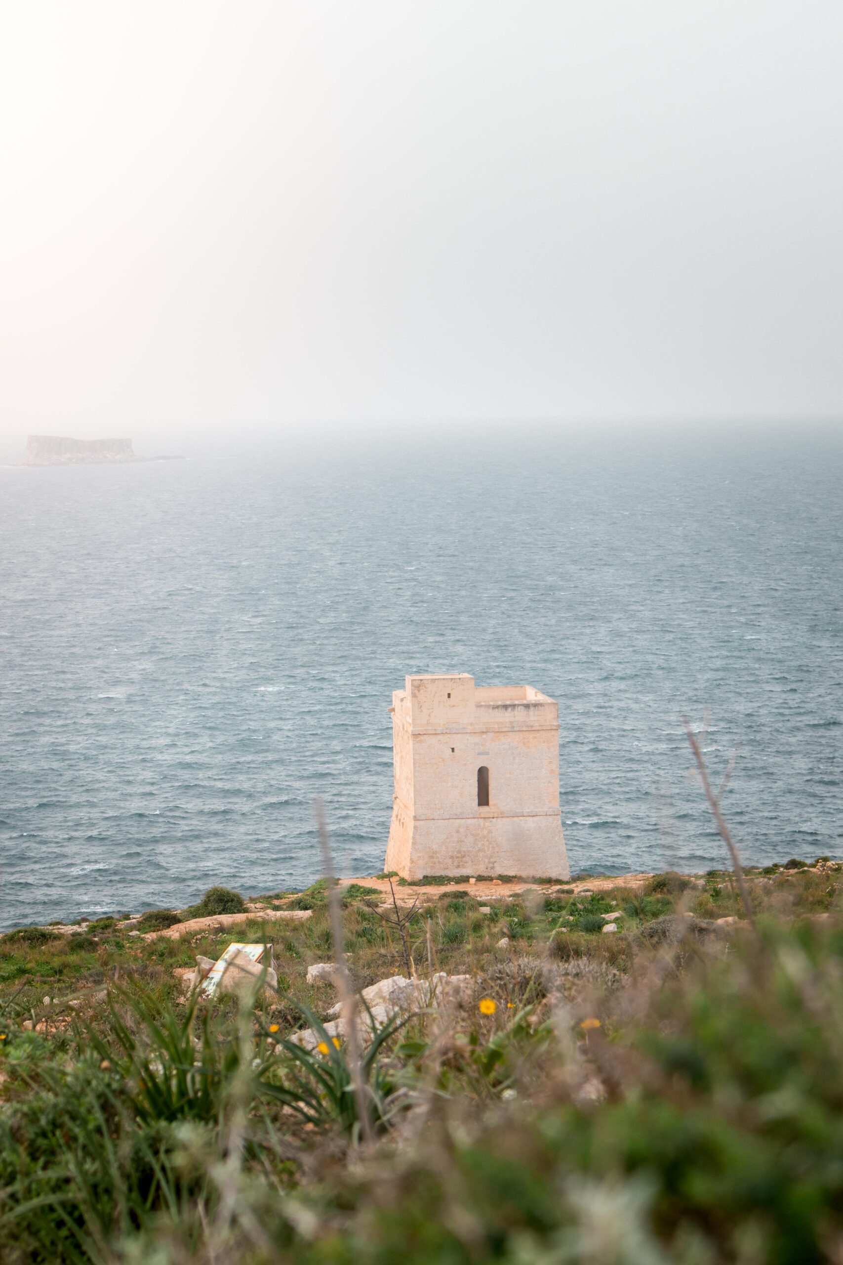 Ħamrija Coastal Tower with the Mediterranean sea and Filfla islet in the background in Malta
