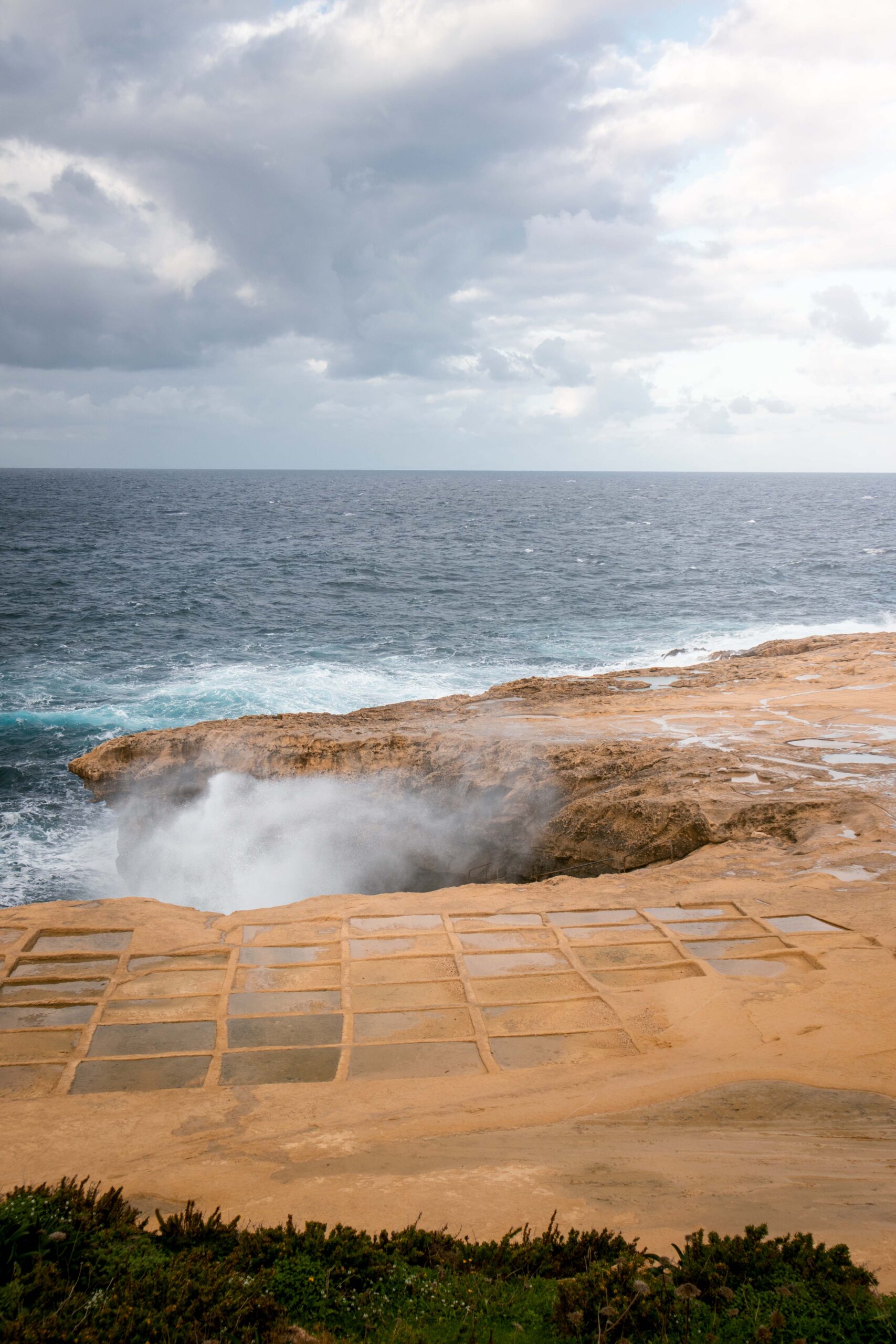 Crashing waves at Xwejni Salt Pans in Gozo island, Malta