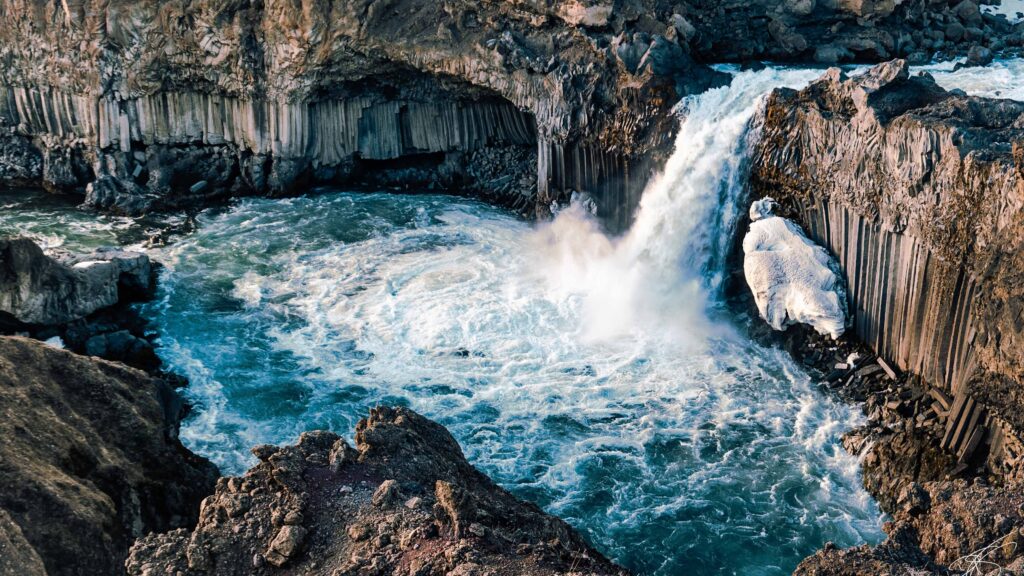 Drone view of the blue water and basalt columns of Aldeyarfoss waterfall, North Iceland