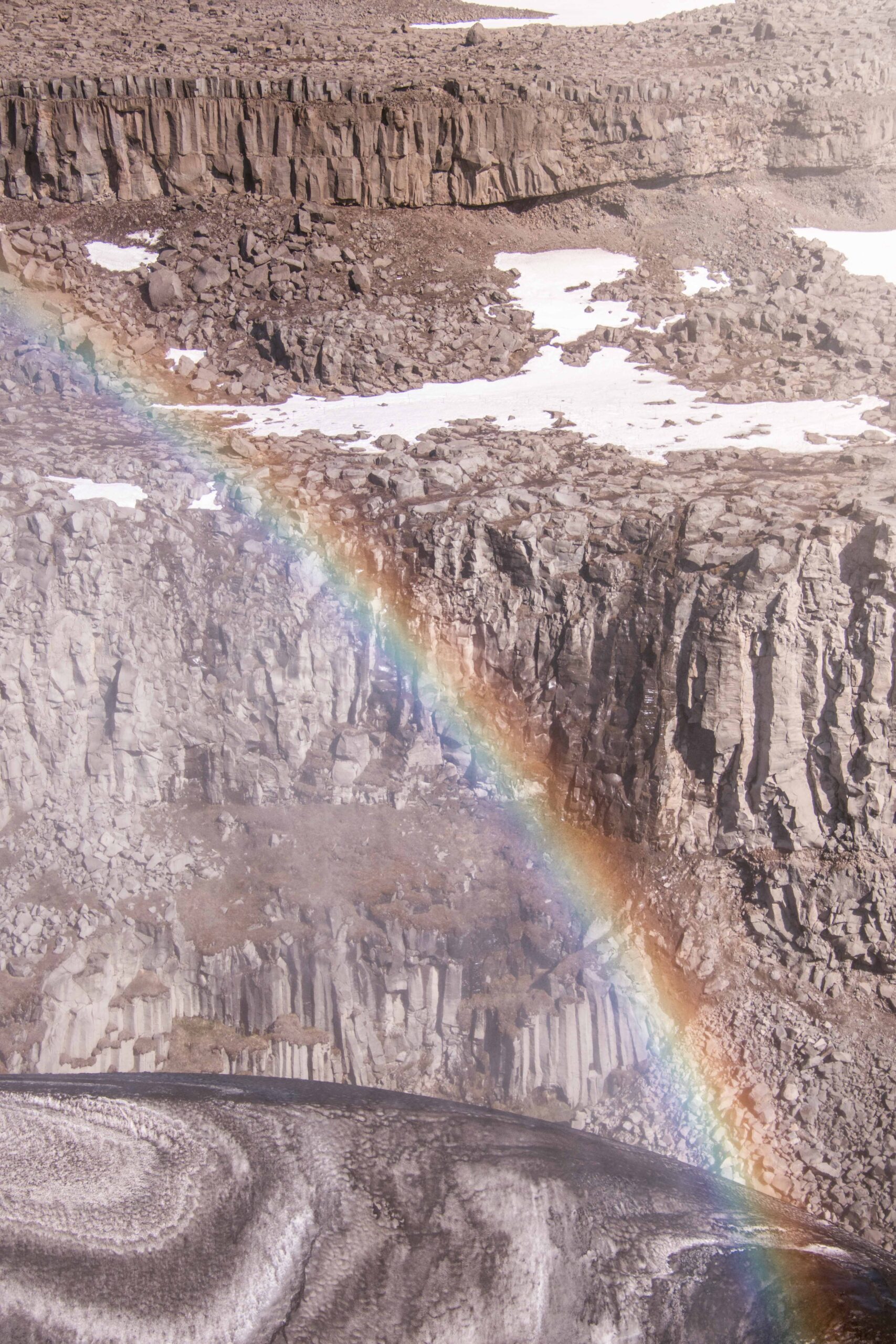 Rainbow and basalt stones at Dettifoss waterfall from East lookout, North Iceland