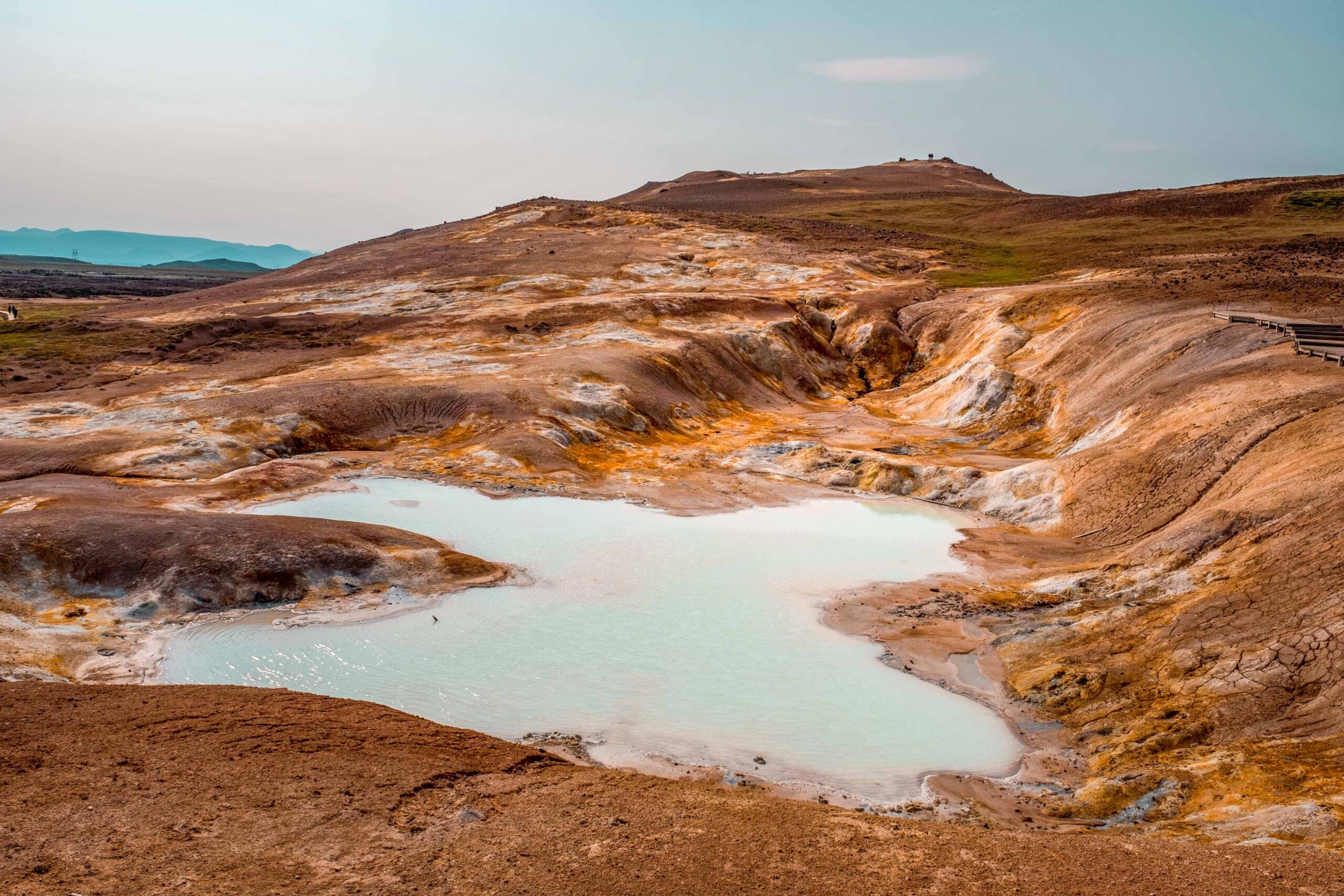 Leirhnjukur's hot geothermal milky blue lake on a hiking trail at Krafla volcanic area near Lake Mývatn, North Iceland