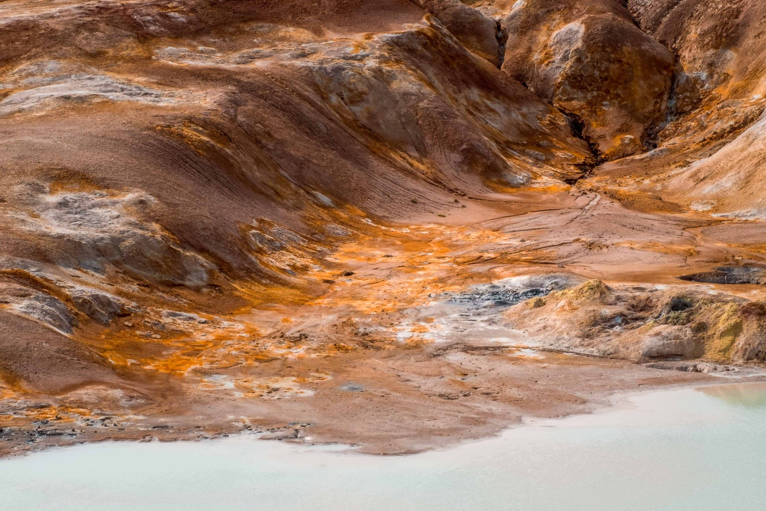 Leirhnjukur's hot geothermal milky blue lake on a hiking trail at Krafla volcanic area near Lake Mývatn, North Iceland