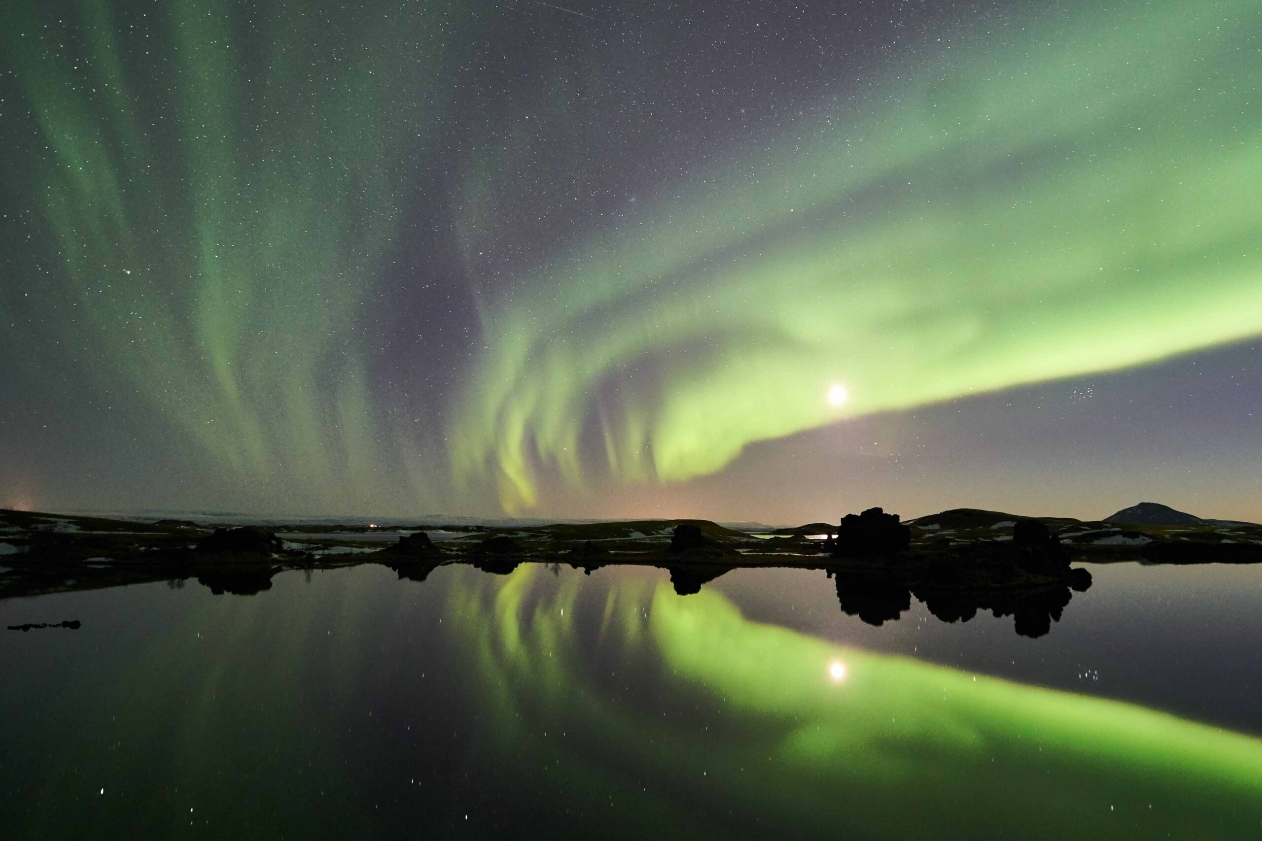 Green northern lights over Lake Mývatn , North Iceland