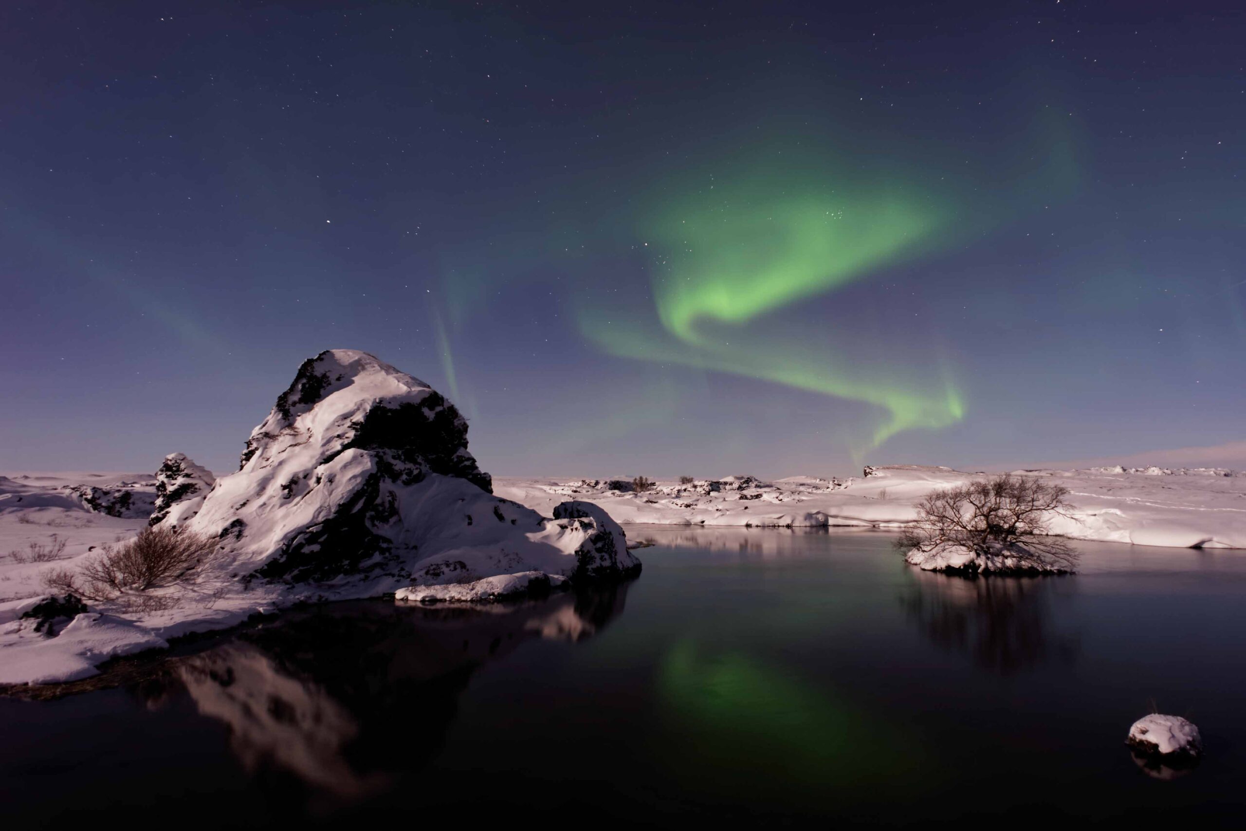 Snow and Green northern lights over Lake Mývatn , North Iceland