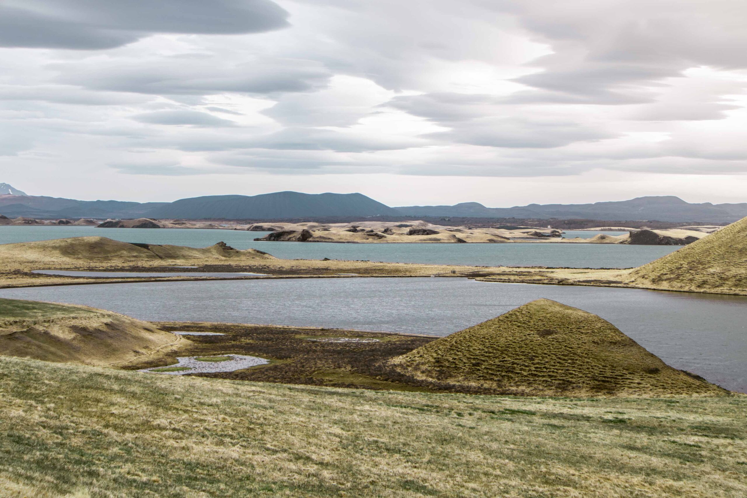 Panoramic view of pseudocraters and distant view of Hverfjall crater at Skutustadagigar in Lake Mývatn area, North Iceland