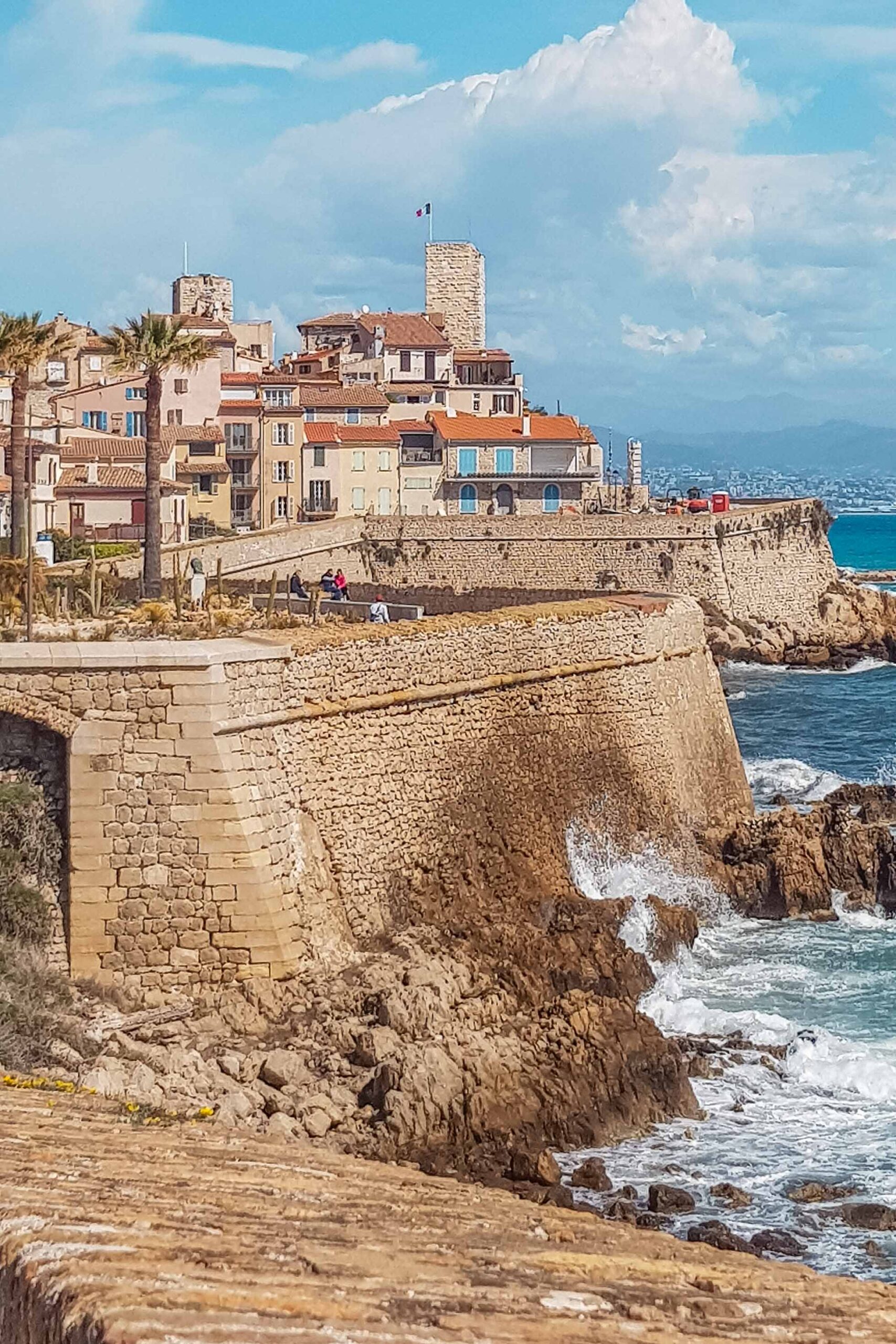 View of the Old Town of Antibes featuring battlements and afar view of the castle-museum Picasso tower in Antibes, France
