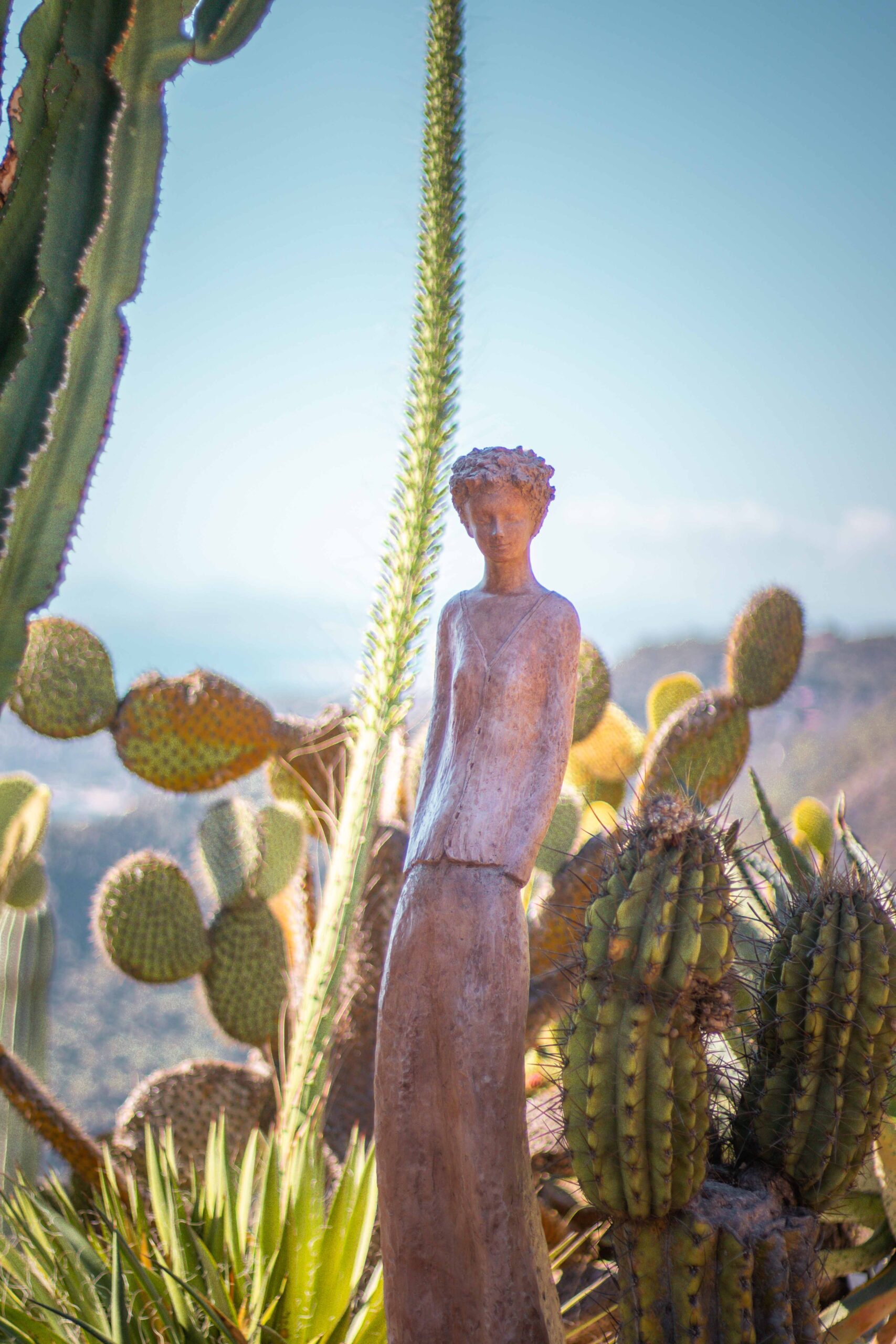 Close-up of a statue made by Jean-Philippe Richard surrounded by cacti in the Eze Exotic Garden on a sunny day in Eze Village, France