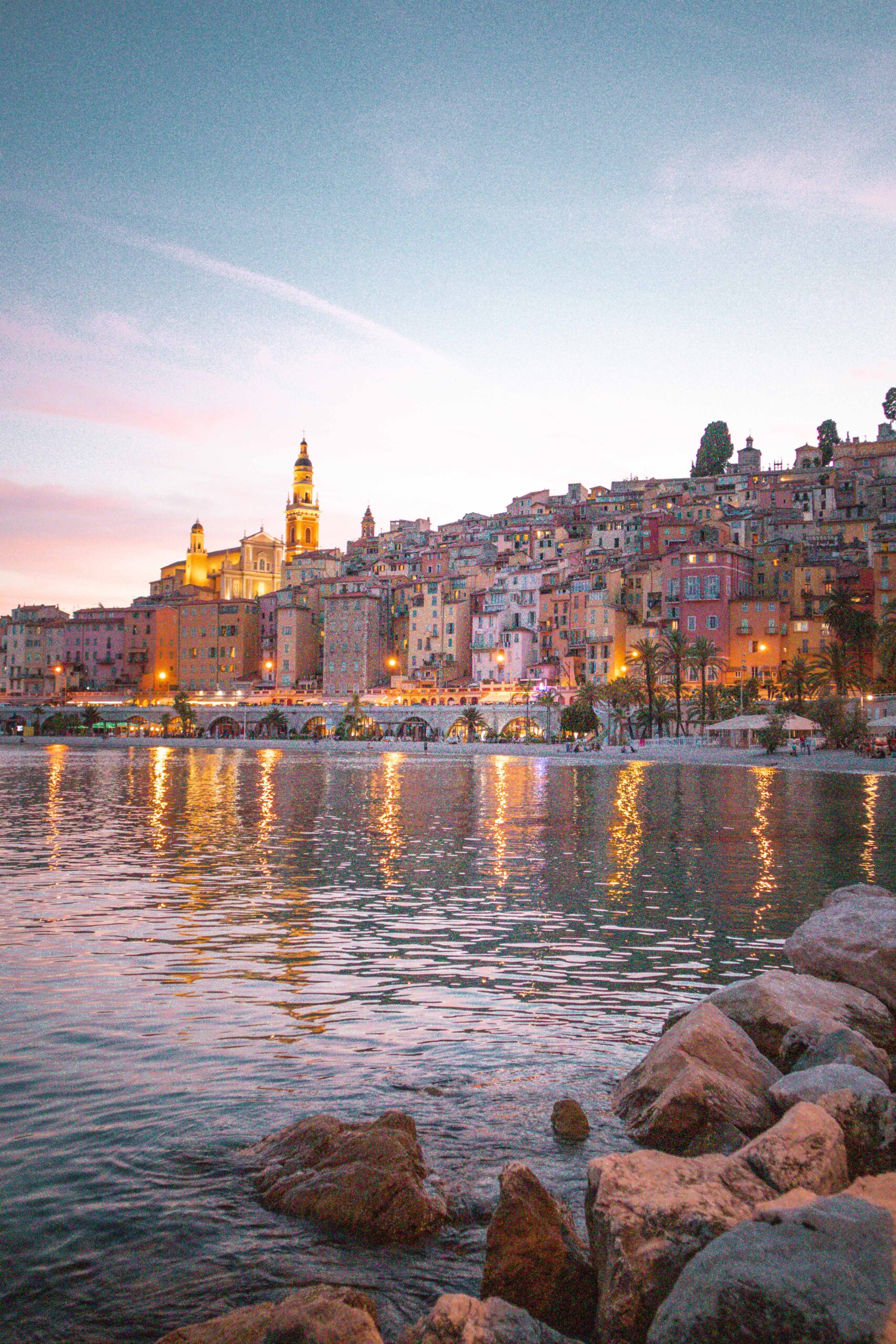 Panoramic view of Menton's waterfront during sunset in Menton, France