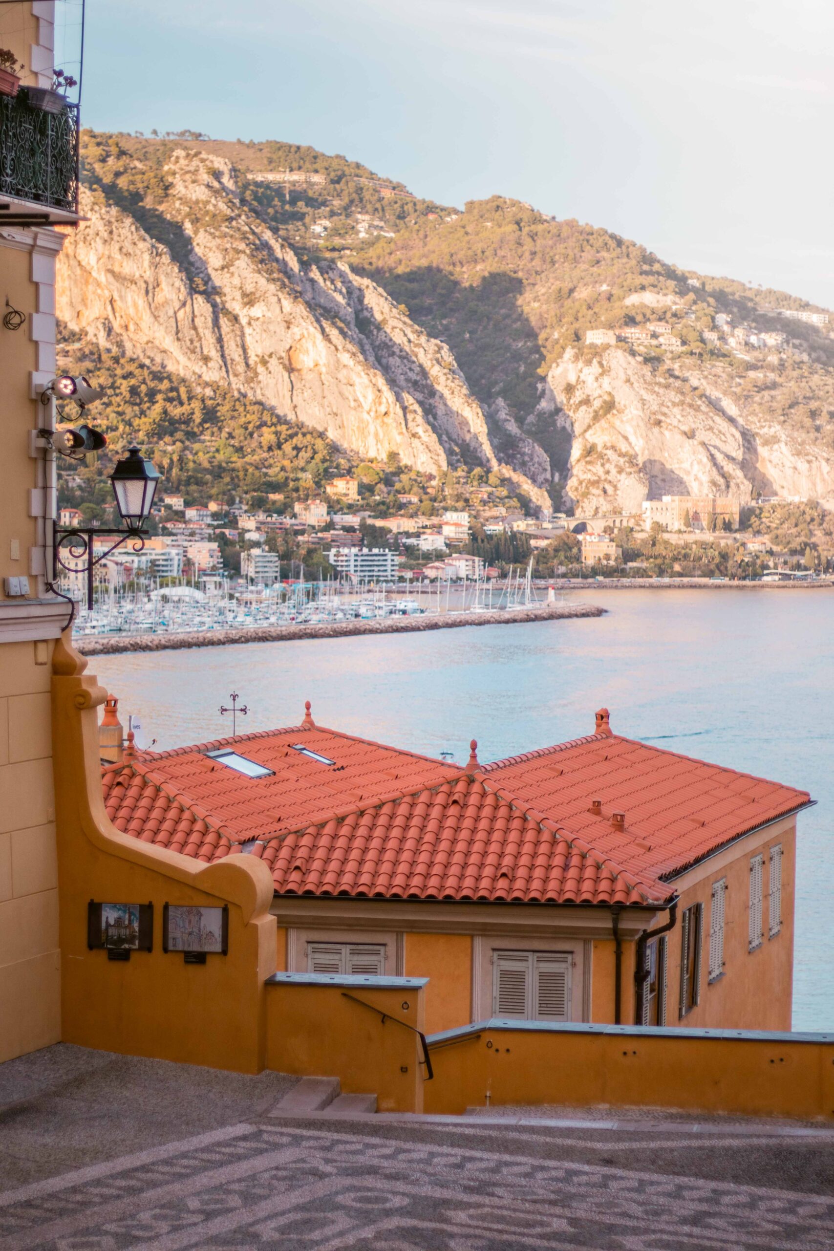 View of cliffs, Menton Port and yellow house rooftop as seen from the Basilica of Saint Michael Archangel Basilica place in Menton, France