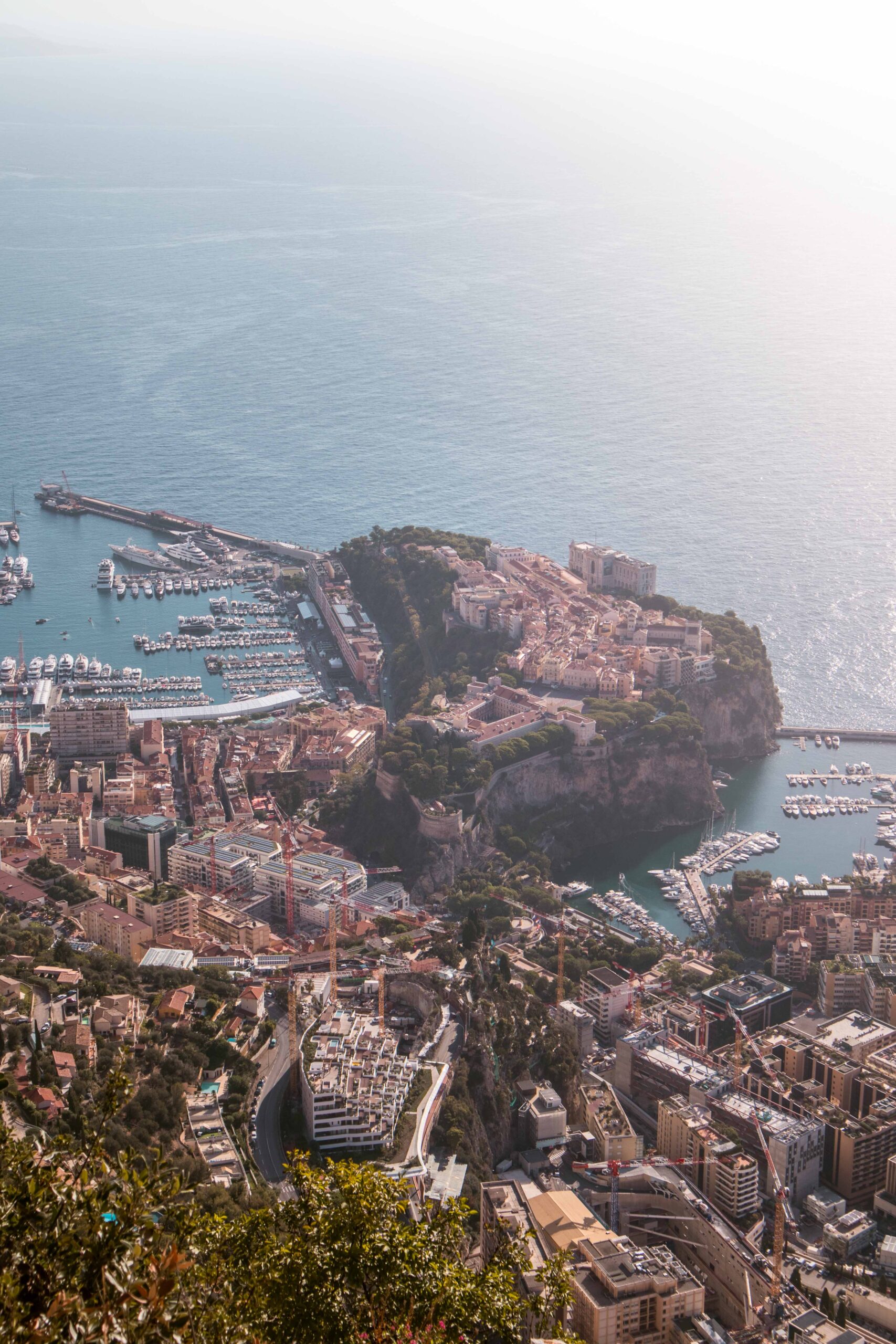 Above view of "The Rock" ("Le Rocher"), the Fontivielle Port and the Hercule Port of Monaco as seen from the Tête de Chien rock promontory viewpoint near La Turbie Village, France