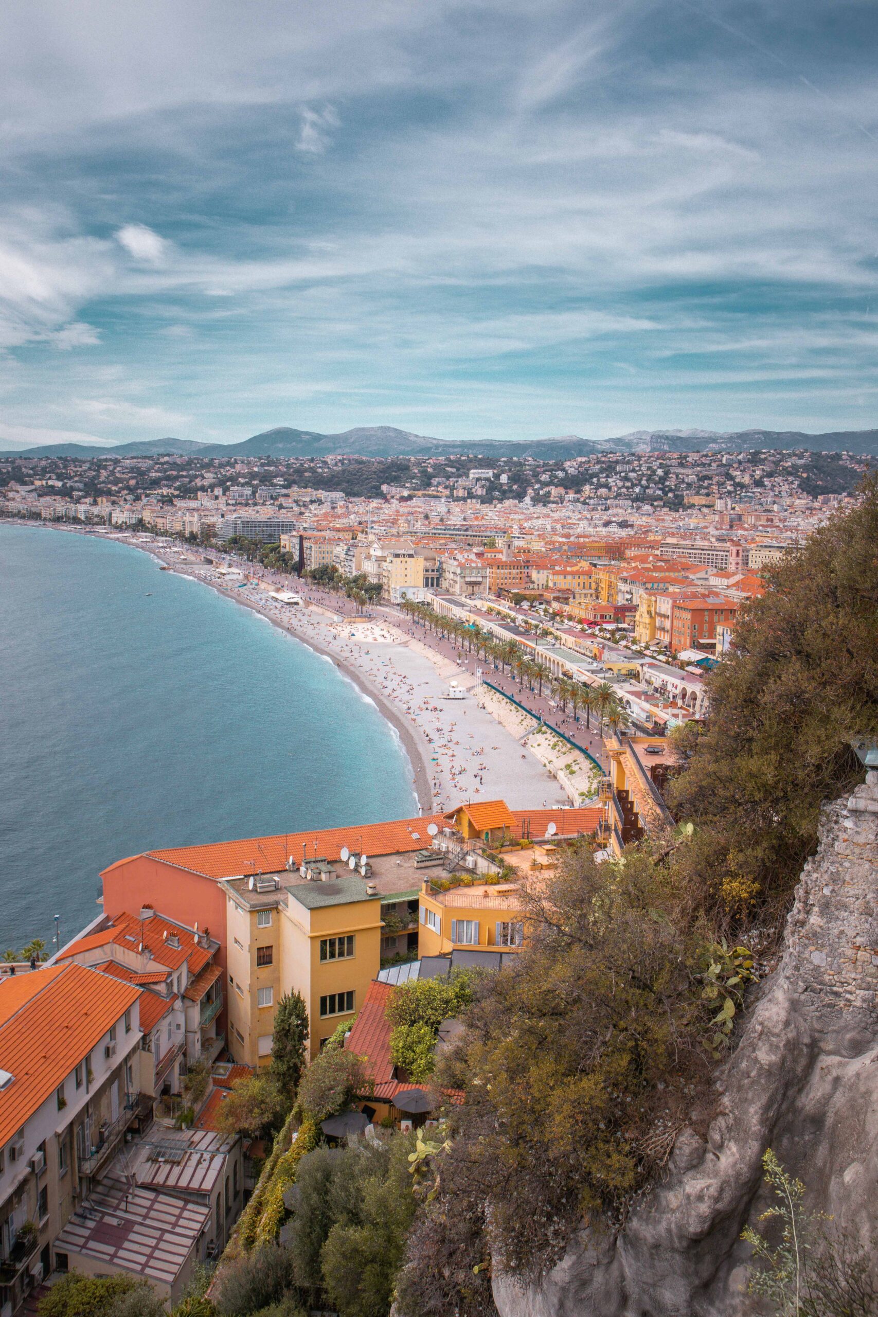Panoramic view of the Promenade des Anglais, the pebble beach and rooftops as seen from the Colline du Château (Castle Hill) park in Nice, France