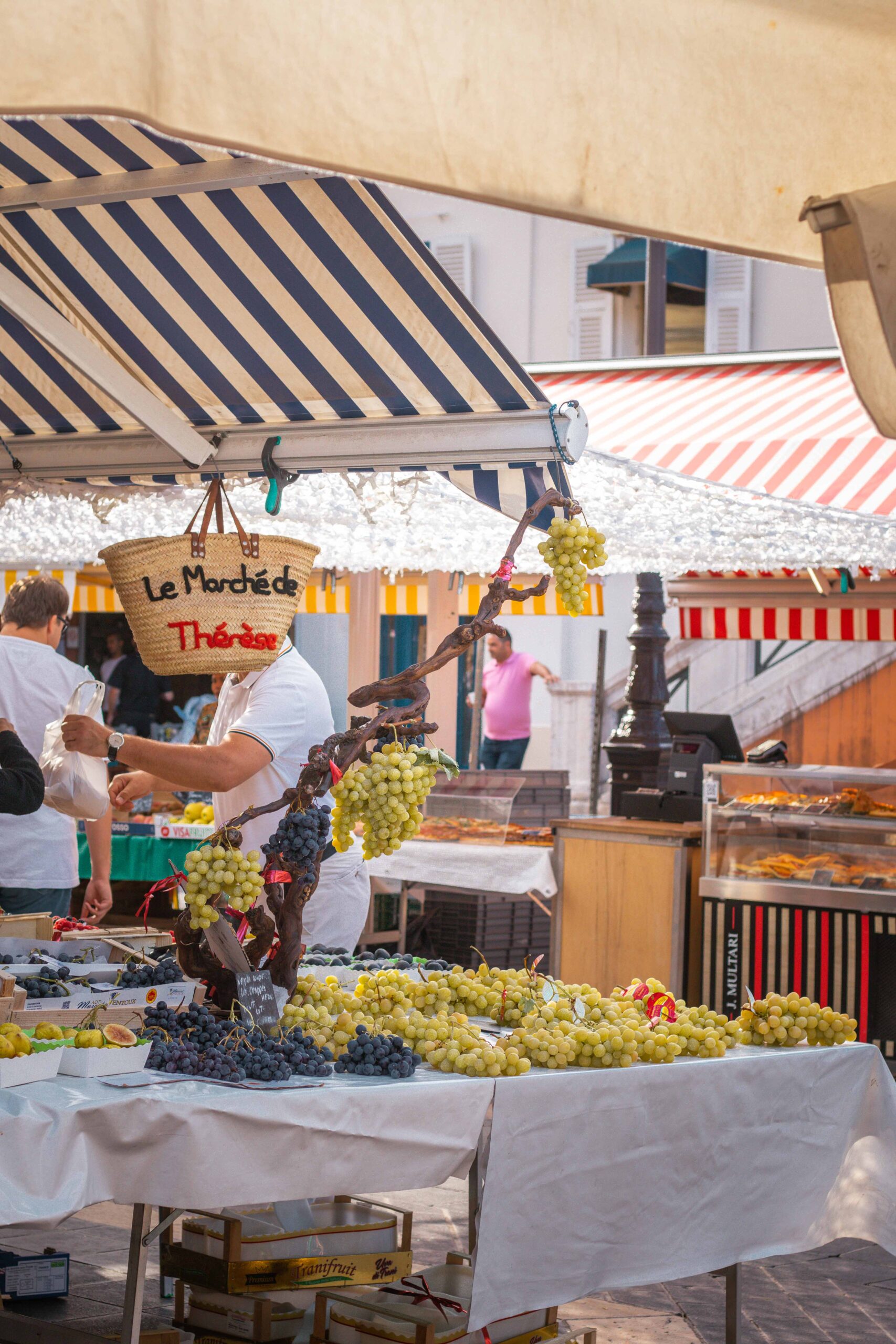 Market stall selling grapes and fruits at the Marché Aux Fleurs Cours Saleya in Nice, France