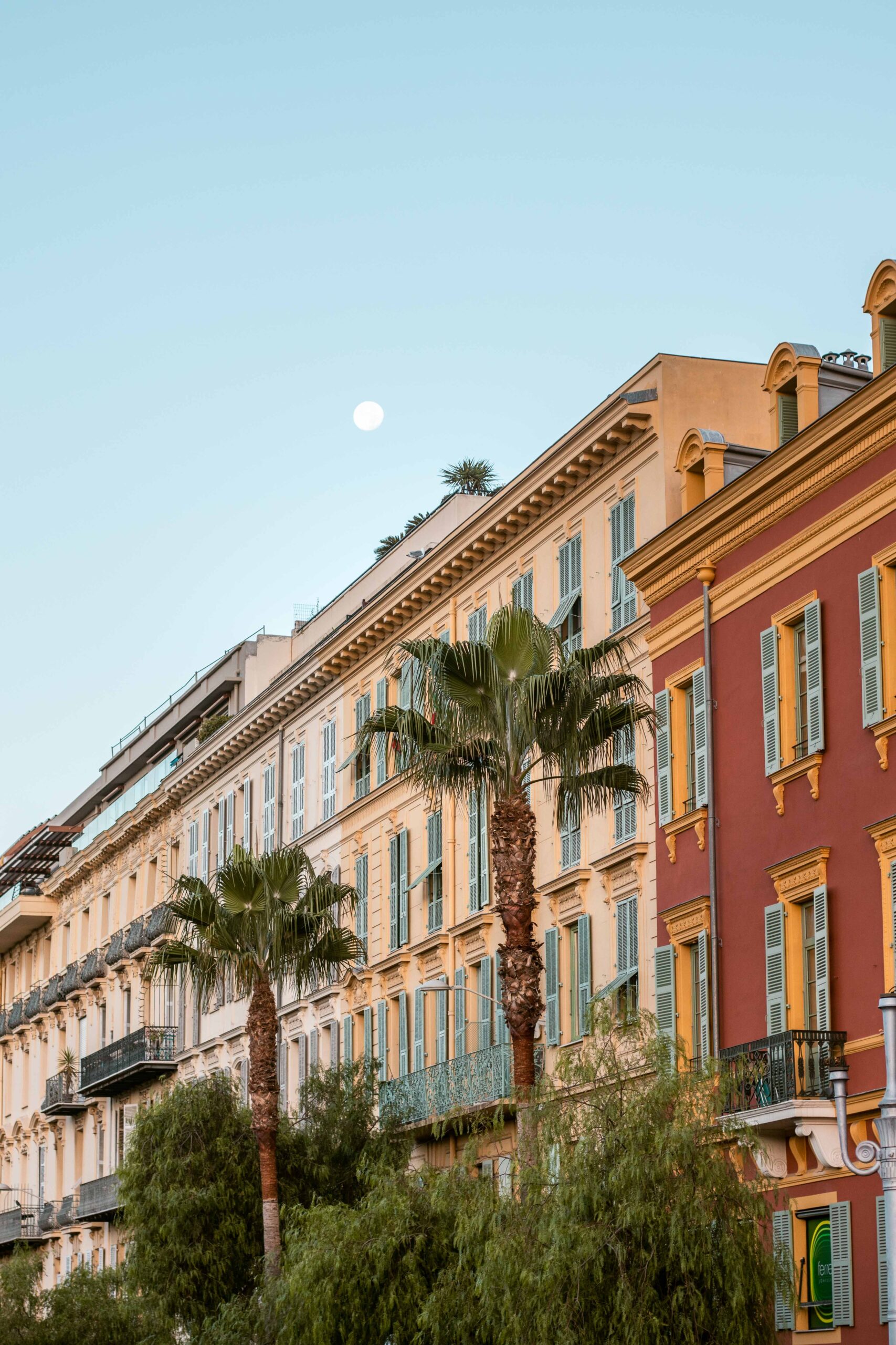 Facades of buildings and palmtrees around Place Masséna in Nice, France